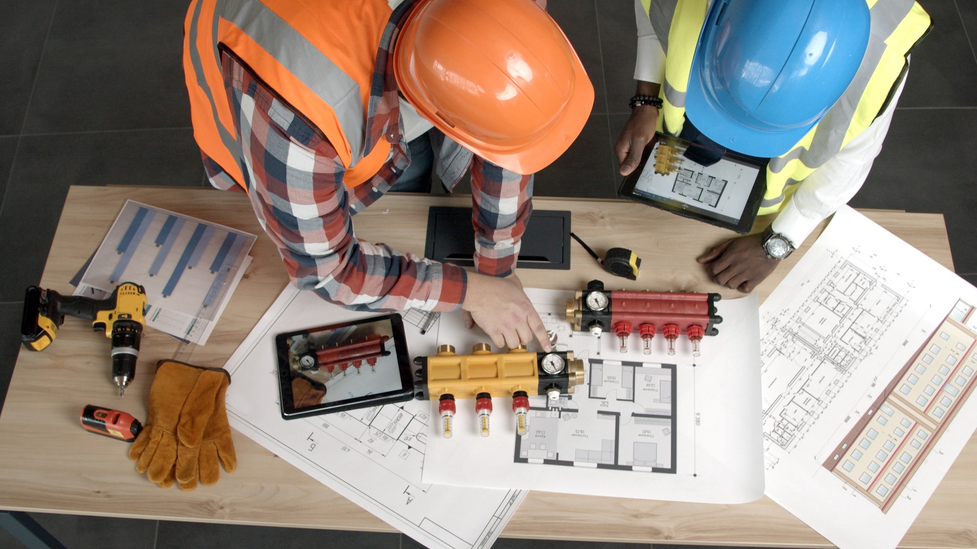 Young architects inspect new blueprints and equipment